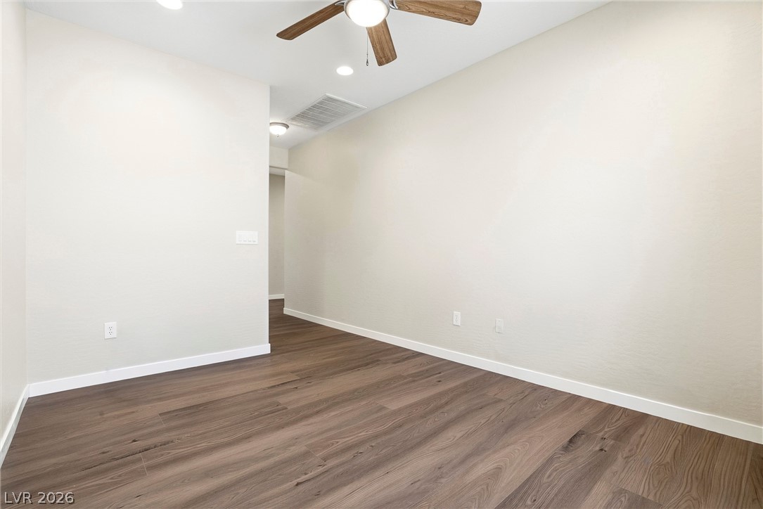 2541 Darda Street Henderson, NV 89044 - Photo 13 of 26 Bright, spacious room featuring rich hardwood flooring and modern ceiling fan.