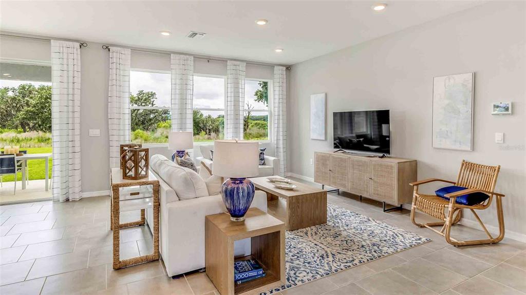 2337 Rikkola Lane Wesley Chapel, FL 33543 - Photo 7 of 17 a living room with furniture and a flat screen tv