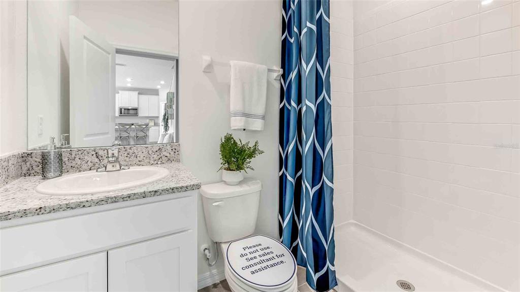 2337 Rikkola Lane Wesley Chapel, FL 33543 - Photo 9 of 17 a bathroom with a sink a toilet and a mirror