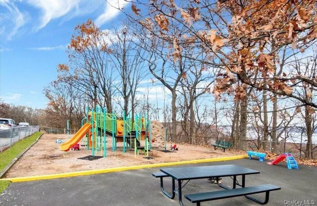 an empty room with wooden floor and closet area