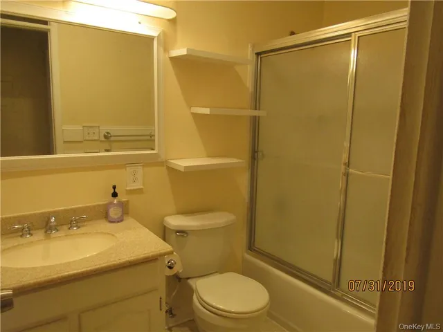 a bathroom with a sink mirror toilet and shower