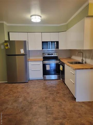 a kitchen with stainless steel appliances granite countertop a stove a refrigerator and a sink