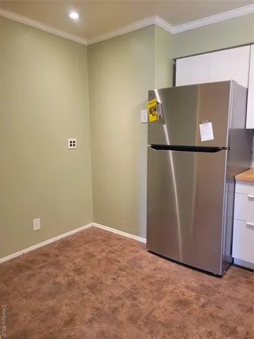 a kitchen with stainless steel appliances granite countertop a refrigerator a stove a sink and a microwave