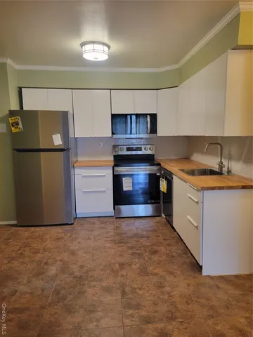 a kitchen with stainless steel appliances a stove and a refrigerator