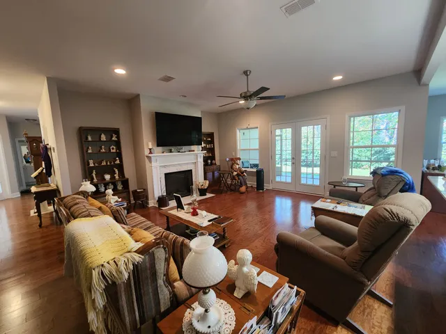 a living room with furniture a flat screen tv and a fireplace