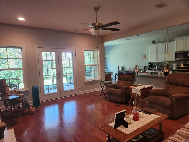 a living room with furniture and a large window