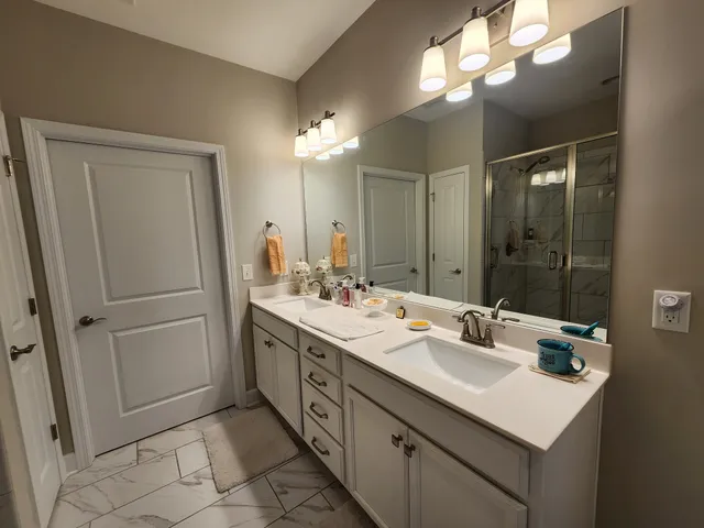 a bathroom with a sink double vanity and a mirror