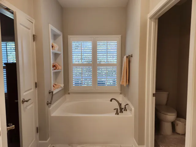 a bathroom with a bathtub and a toilet