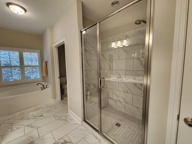 a bathroom with a shower and a bathtub