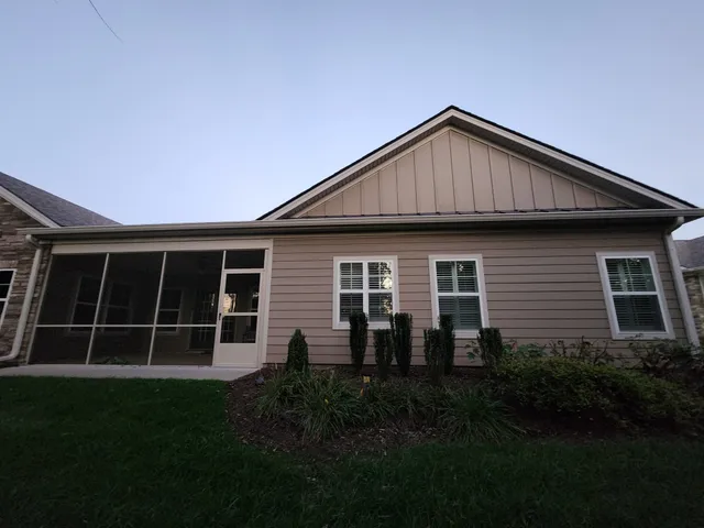 a view of backyard of house with green space
