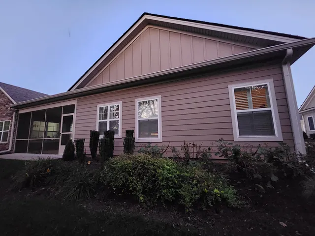a front view of a house with a large window
