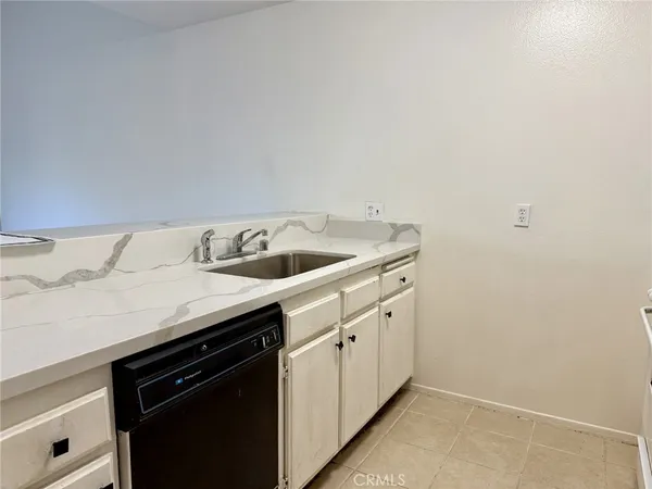 a utility room with sink dryer and washer