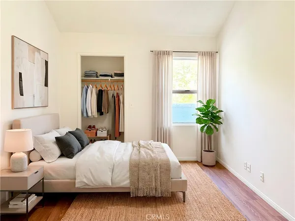 a bedroom with a bed and a potted plant
