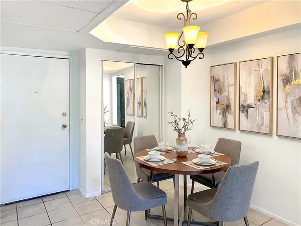 a dining room with furniture and chandelier