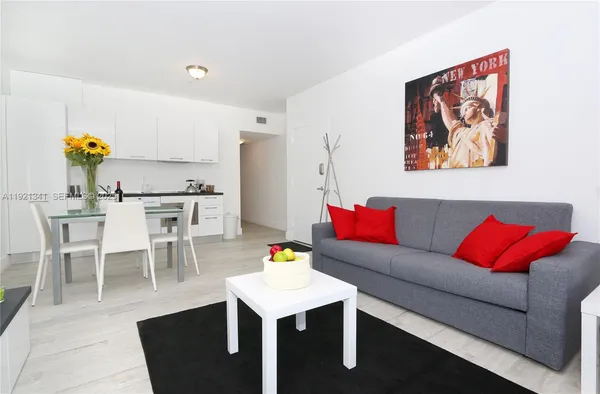 a living room with furniture and kitchen view