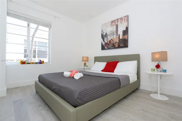 a bedroom with a bed and window