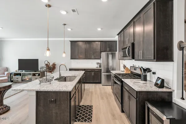 a kitchen with a sink stove and refrigerator