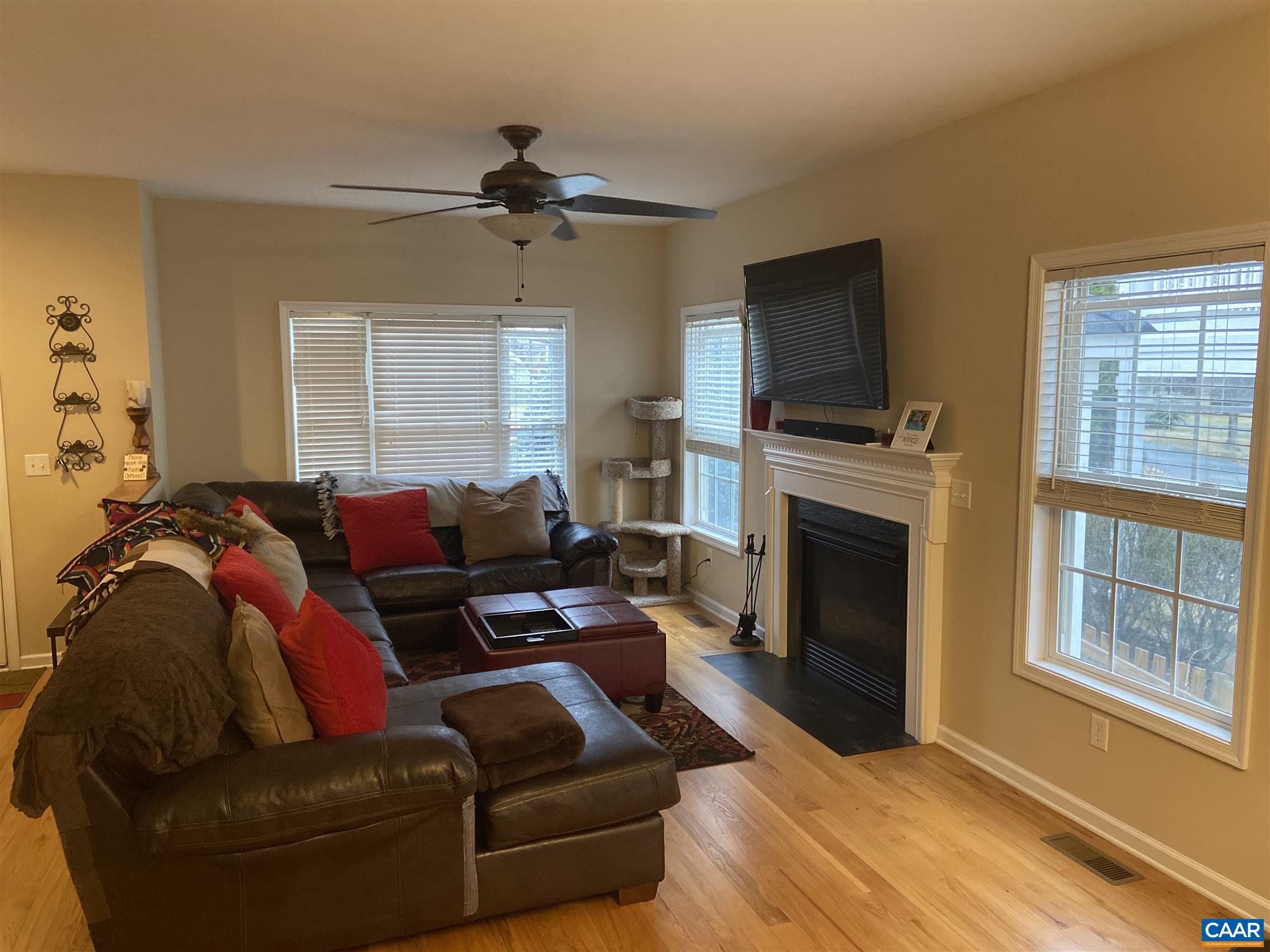 911 Raymond Road Charlottesville, VA 22902 - Photo 7 of 24 a living room with furniture a flat screen tv and a fireplace