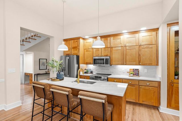 a kitchen with a sink cabinets and wooden floor