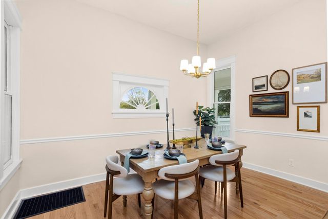a view of a dining room with furniture window and wooden floor