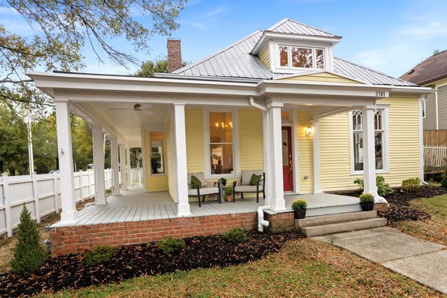 a front view of a house with a outdoor seating