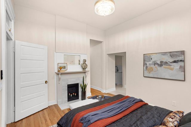 a bedroom with a bed and a fireplace