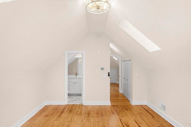 a view of a bedroom with wooden floor