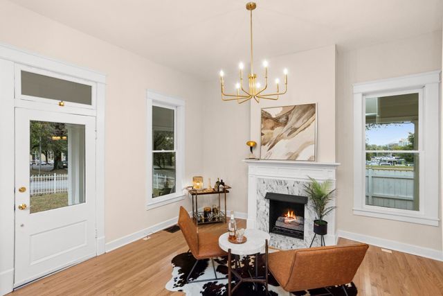 a living room with a fireplace dining table and a fireplace