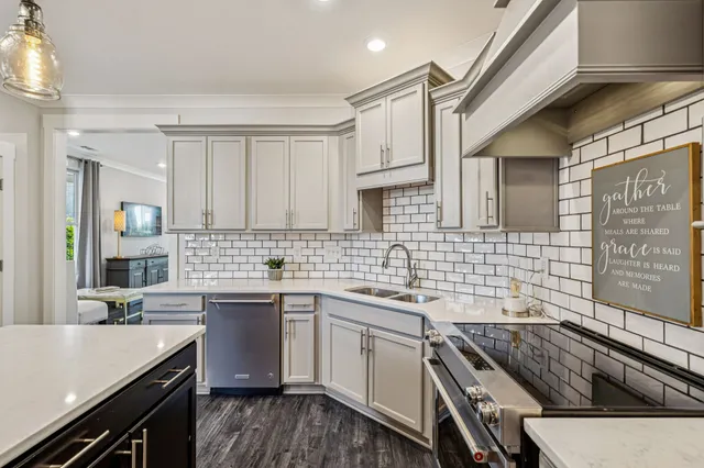 a kitchen with a stove a refrigerator and a dining table with wooden floor