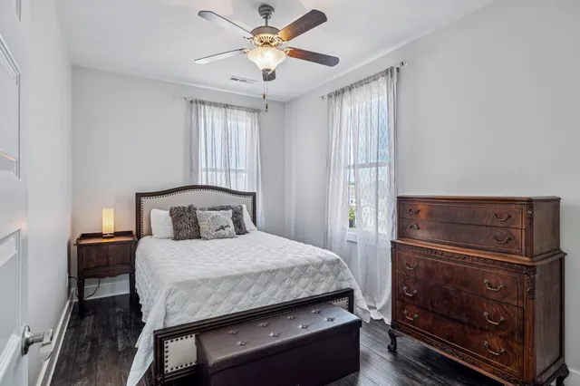 a bathroom with a sink a toilet a mirror a bathtub and shower