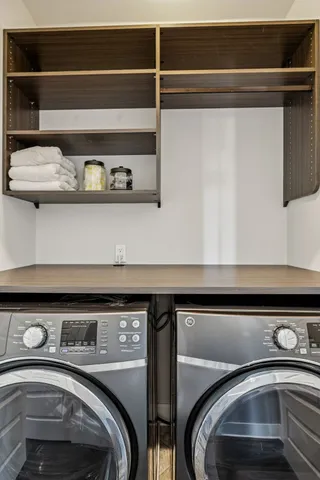 a bedroom with a bed a dresser and window