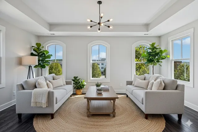 a view of a brick house with a yard and potted plants