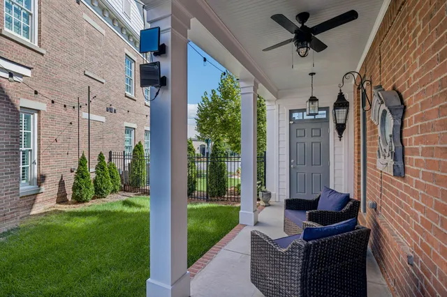 a view of a yard with flower plants and wooden fence