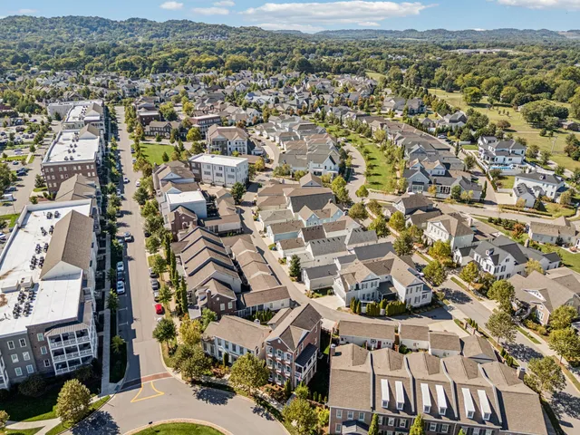 an aerial view of a house with garden space and street view