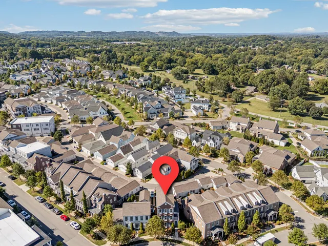 a front view of a house with a yard and outdoor seating
