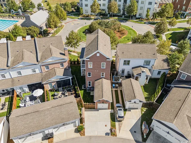 an aerial view of a residential houses with city view