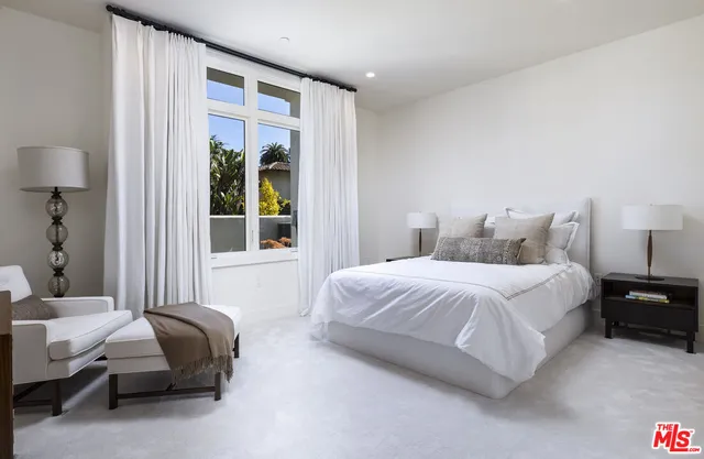 a bedroom with bed and a couch