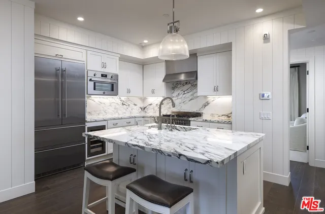 a bed room with a bed and painting on the wall