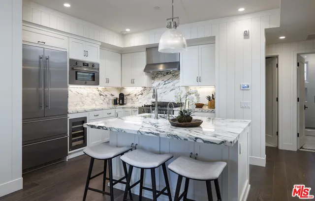 a bathroom with a granite countertop sink a toilet a mirror and shower