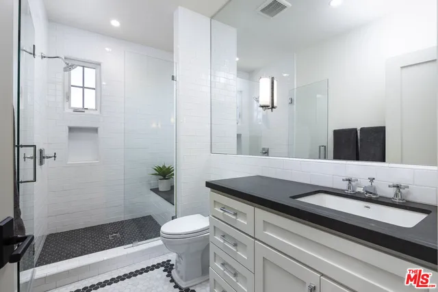 a bedroom with a large bed and a painting on the wall