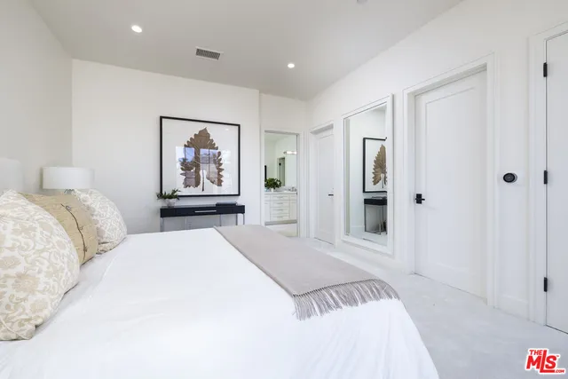 a bathroom with a granite countertop sink toilet a large mirror a bathtub and shower