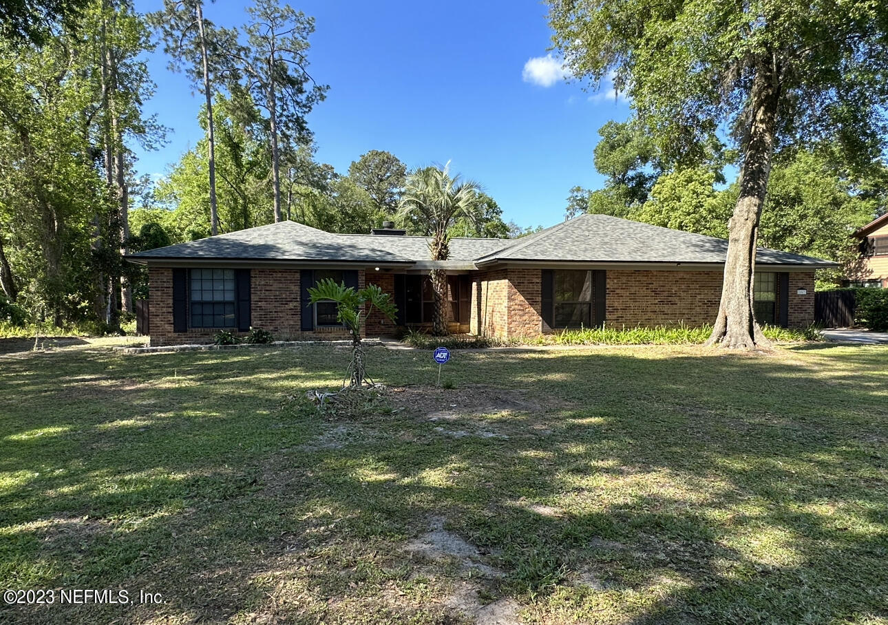 2842 Plummer Cove Road Jacksonville, FL 32223 - Photo 4 of 4 a front view of a house with a garden