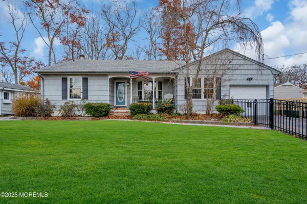 a front view of house with yard and outdoor seating