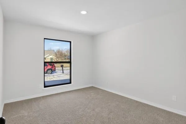 an empty room with painting on the wall