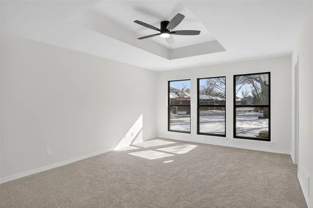 a view of a livingroom with a ceiling fan and window