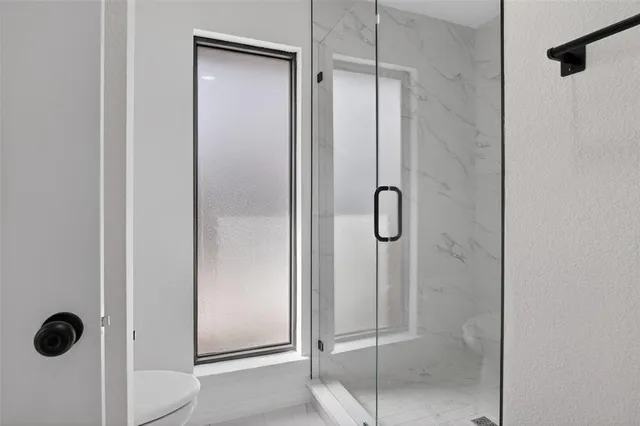 a bathroom with a glass shower door