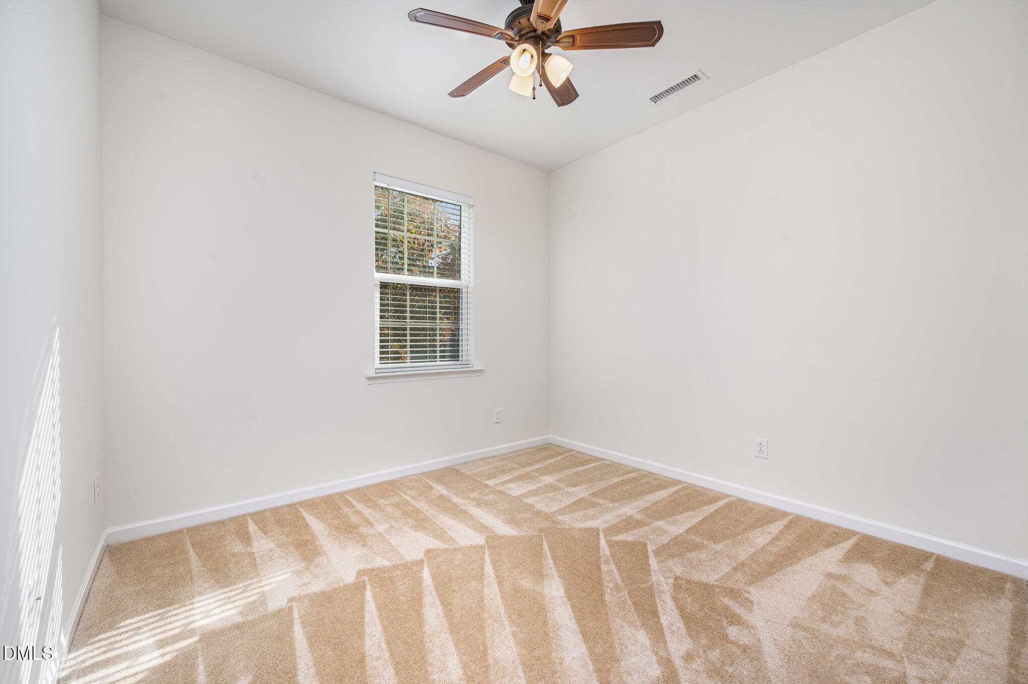 104 Oak Rise Lane Fuquay-Varina, NC 27526 - Photo 9 of 29 a view of a room with a window and a ceiling fan