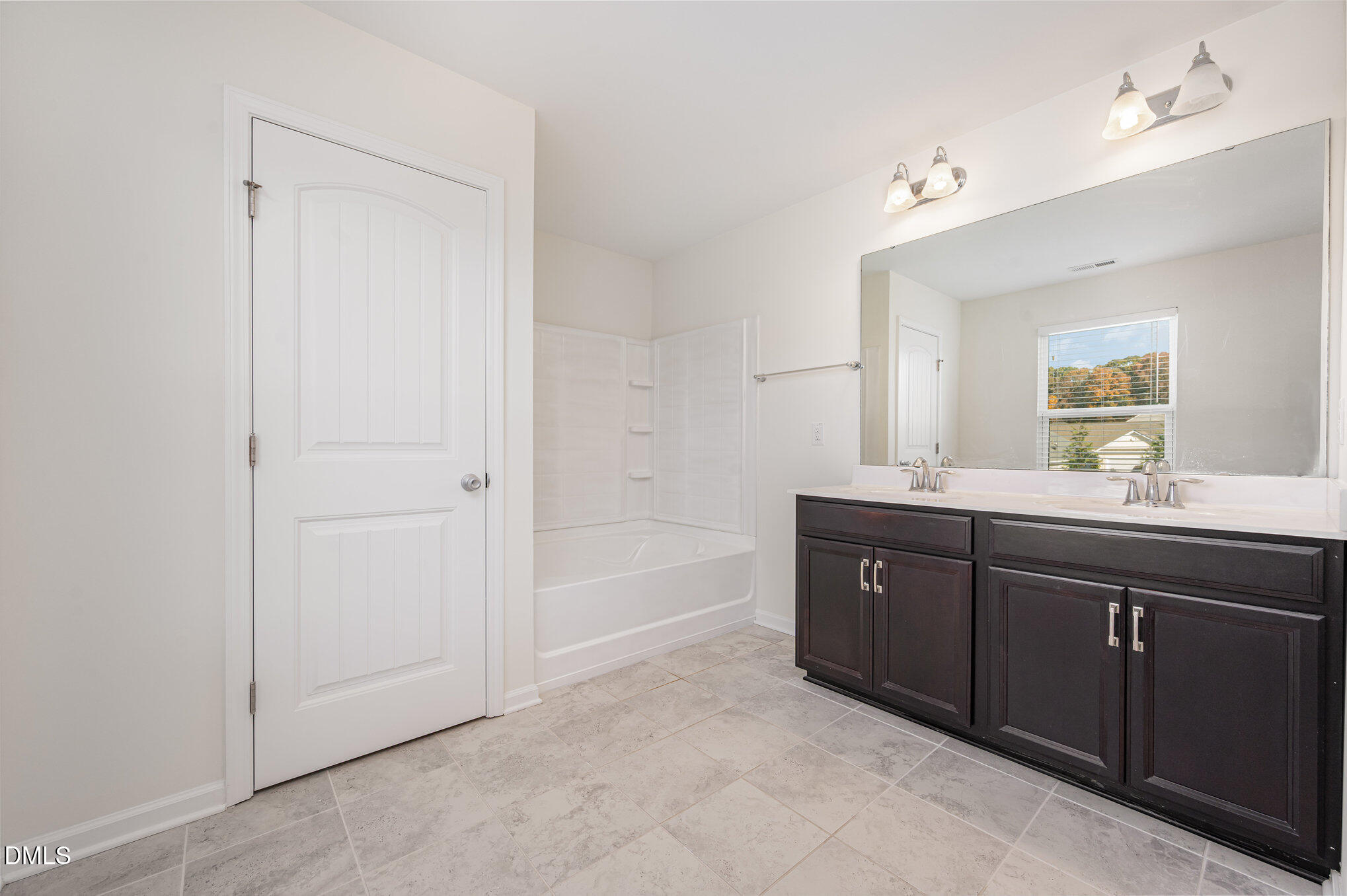 104 Oak Rise Lane Fuquay-Varina, NC 27526 - Photo 16 of 29 a spacious bathroom with a tub sink and mirror