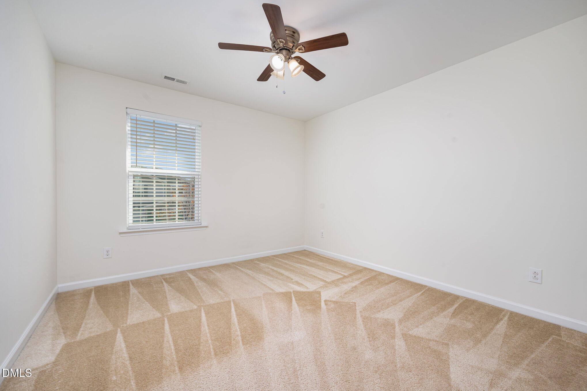 104 Oak Rise Lane Fuquay-Varina, NC 27526 - Photo 19 of 29 an empty room with windows and fan
