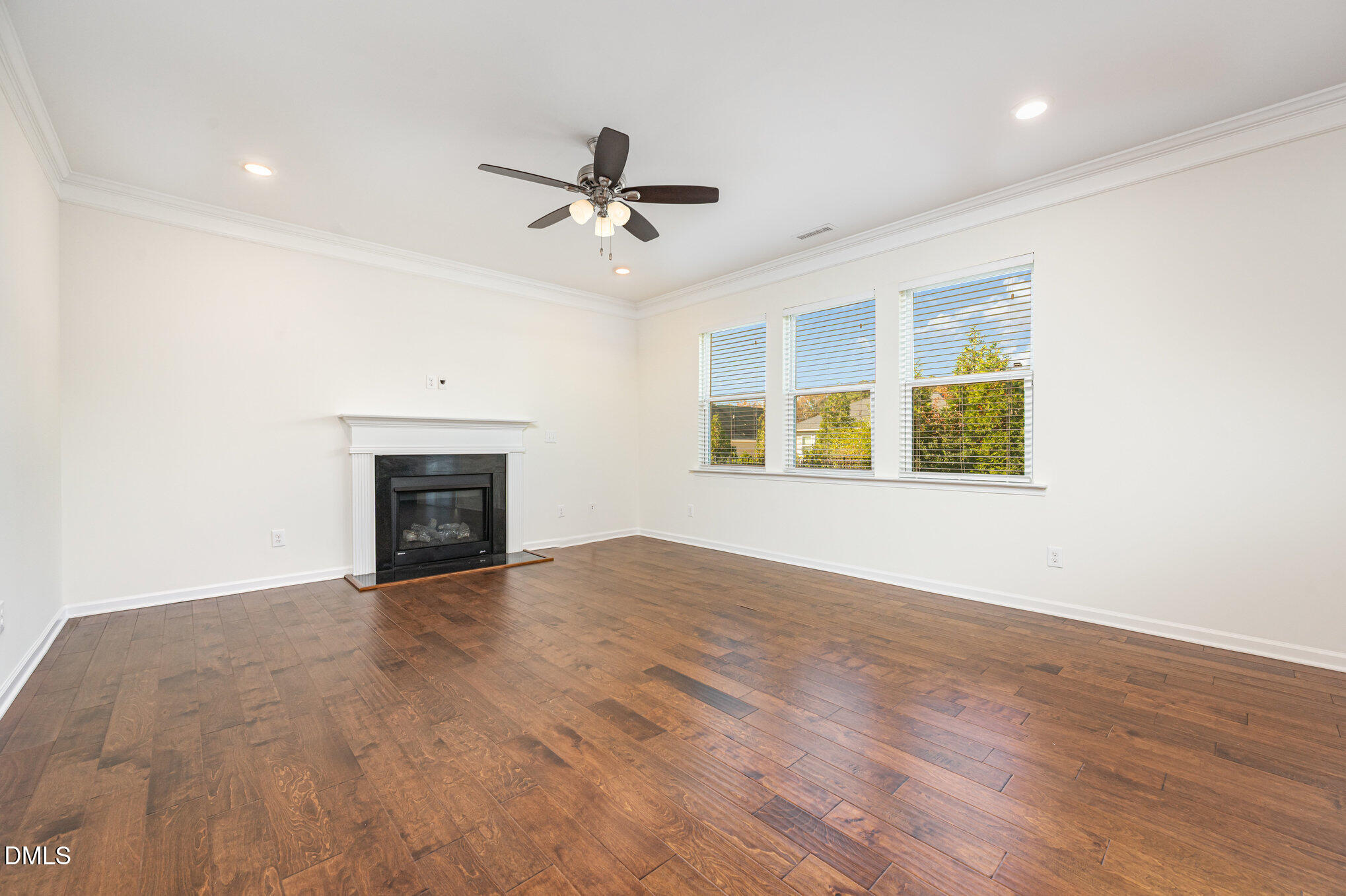 104 Oak Rise Lane Fuquay-Varina, NC 27526 - Photo 3 of 29 a view of an empty room with a fireplace and a window
